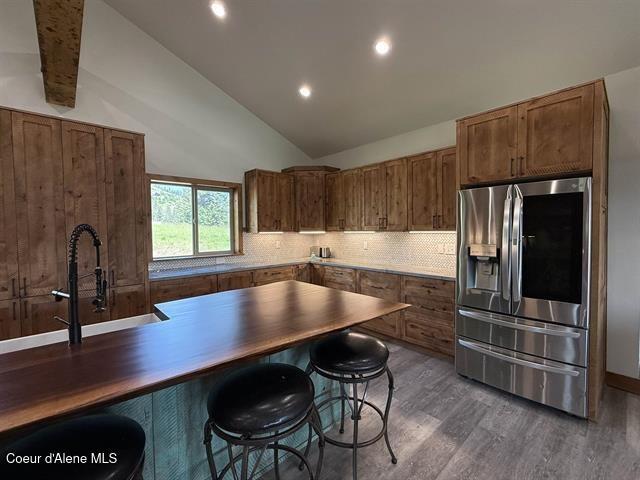 240 Canyon Dr, Kooskia, ID 83539 - kitchen with stainless steel refrigerator with ice dispenser, dark wood-style flooring, backsplash, recessed lighting, and brown cabinets