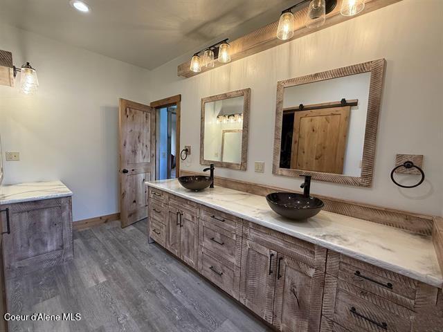240 Canyon Dr, Kooskia, ID 83539 - full bath featuring wood finished floors, double vanity, and baseboards