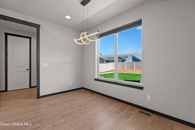 6568 N Downing Ln, Coeur Dalene, ID 83815 - unfurnished room with baseboards, light wood-style floors, a chandelier, and recessed lighting