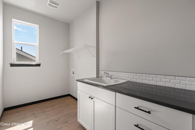 6568 N Downing Ln, Coeur Dalene, ID 83815 - laundry area featuring light wood-style floors, baseboards, hookup for a washing machine, and cabinet space