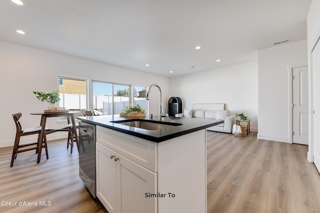 701 N Creative Way, Post Falls, ID 83854 - kitchen with a sink, dark countertops, stainless steel dishwasher, light wood-type flooring, and white cabinets