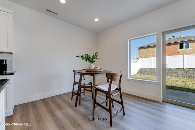 701 N Creative Way, Post Falls, ID 83854 - dining room featuring wood finished floors, baseboards, and recessed lighting