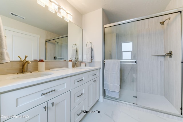 701 N Creative Way, Post Falls, ID 83854 - bathroom with a shower stall, double vanity, and marble finish flooring