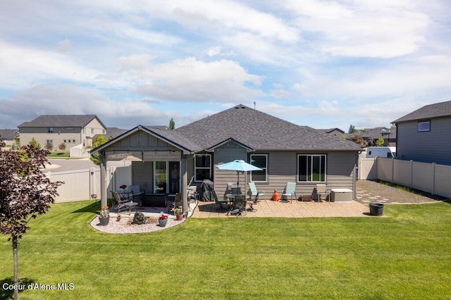 4615 N Connery Loop, Post Falls, ID 83854 - back of property with a patio, a shingled roof, and board and batten siding