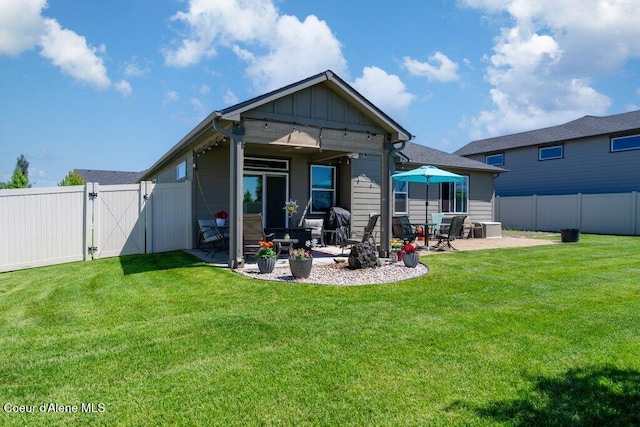 4615 N Connery Loop, Post Falls, ID 83854 - rear view of property featuring a patio, board and batten siding, and a gate