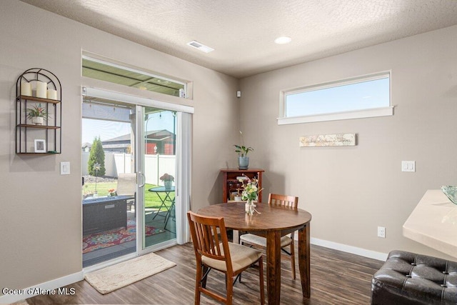 4615 N Connery Loop, Post Falls, ID 83854 - dining area with dark wood-style floors, baseboards, and a textured ceiling