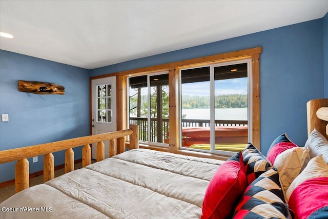 7373 E Hayden Haven Rd, Hayden, ID 83835 - bedroom featuring access to outside, multiple windows, and a water view
