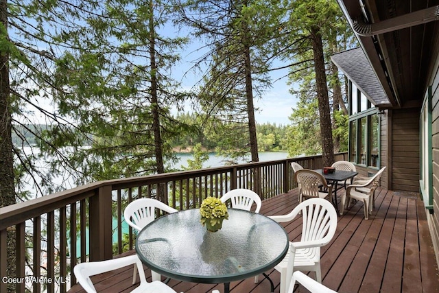 7373 E Hayden Haven Rd, Hayden, ID 83835 - wooden deck featuring outdoor dining area and a water view
