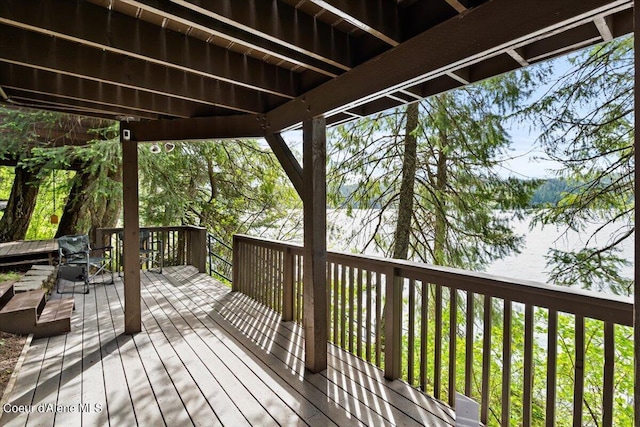 7373 E Hayden Haven Rd, Hayden, ID 83835 - wooden deck with outdoor dining area and a water view