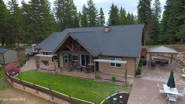 995 S Saddleback Dr, Coeur Dalene, ID 83814 - rear view of house with a gazebo, a patio area, and a shingled roof