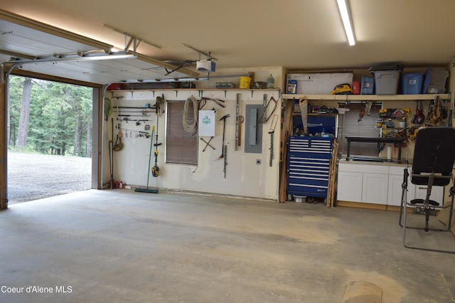 995 S Saddleback Dr, Coeur Dalene, ID 83814 - garage featuring electric panel, a workshop area, and a garage door opener