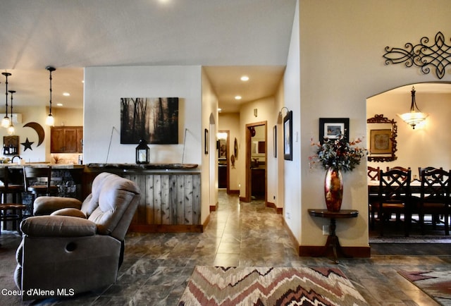 995 S Saddleback Dr, Coeur Dalene, ID 83814 - living room featuring dark stone finish floors, baseboards, recessed lighting, and arched walkways