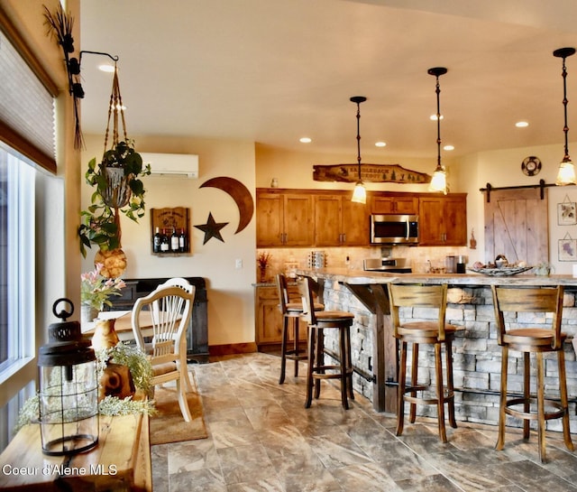 995 S Saddleback Dr, Coeur Dalene, ID 83814 - kitchen featuring stainless steel appliances, brown cabinets, decorative backsplash, light marble finish flooring, and decorative light fixtures