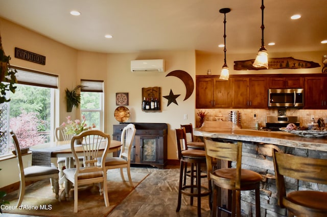 995 S Saddleback Dr, Coeur Dalene, ID 83814 - kitchen with stainless steel appliances, a wall mounted AC, recessed lighting, tasteful backsplash, and pendant lighting