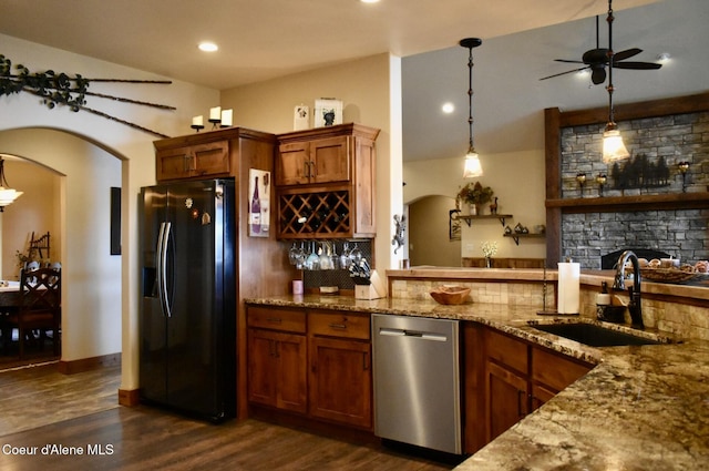995 S Saddleback Dr, Coeur Dalene, ID 83814 - kitchen with dishwasher, black fridge with ice dispenser, a sink, brown cabinets, and ceiling fan