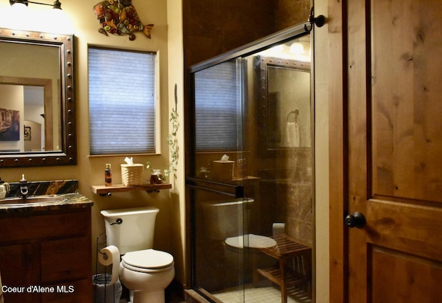 995 S Saddleback Dr, Coeur Dalene, ID 83814 - full bathroom with toilet, vanity, a stall shower, and tile patterned flooring