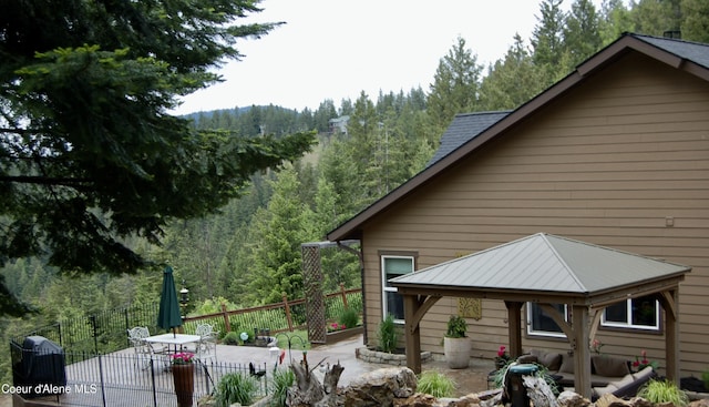 995 S Saddleback Dr, Coeur Dalene, ID 83814 - view of property exterior with a patio, a view of trees, and a gazebo