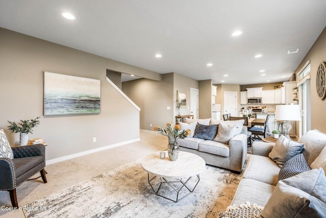 13639 N Apex Way, Hayden, ID 83835 - living room with light carpet, recessed lighting, baseboards, and stairs
