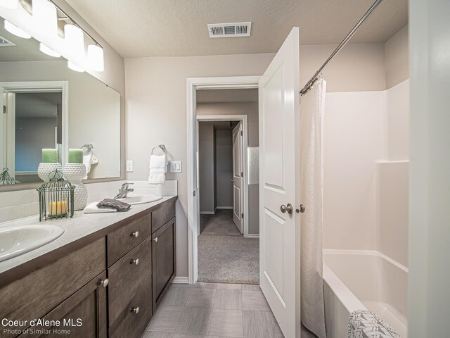13639 N Apex Way, Hayden, ID 83835 - bathroom featuring double vanity and shower / bathtub combination with curtain