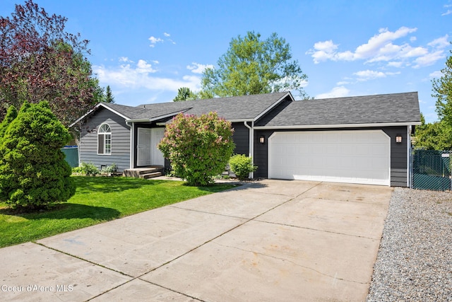 1125 N Shannon Ln, Post Falls, ID 83854 - view of front of home with driveway, an attached garage, and a shingled roof