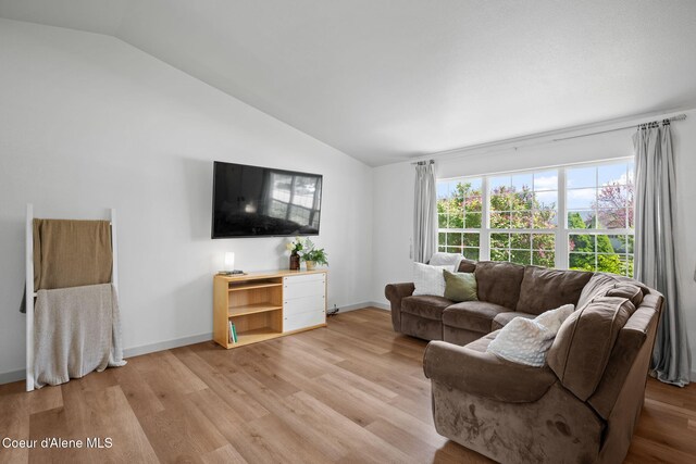 1125 N Shannon Ln, Post Falls, ID 83854 - living area with vaulted ceiling, light wood-type flooring, and baseboards