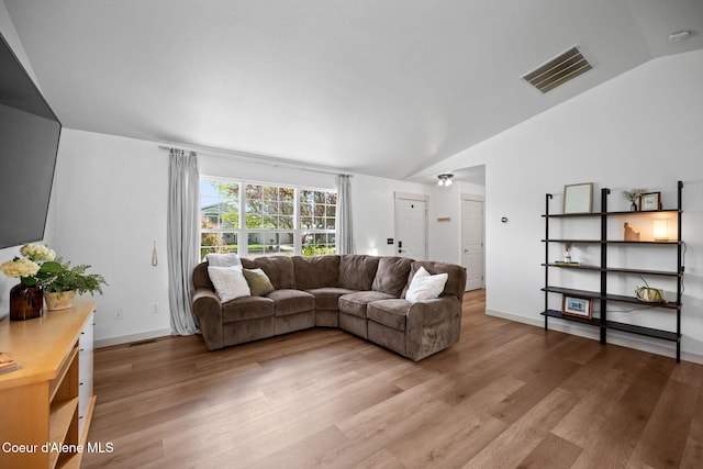 1125 N Shannon Ln, Post Falls, ID 83854 - living area with lofted ceiling, light wood-type flooring, and baseboards