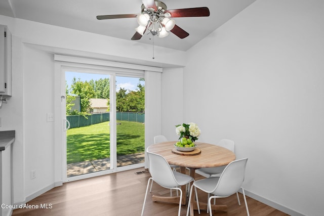 1125 N Shannon Ln, Post Falls, ID 83854 - dining room featuring wood finished floors, a ceiling fan, lofted ceiling, and baseboards