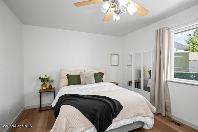 1125 N Shannon Ln, Post Falls, ID 83854 - bedroom with wood finished floors, baseboards, and ceiling fan