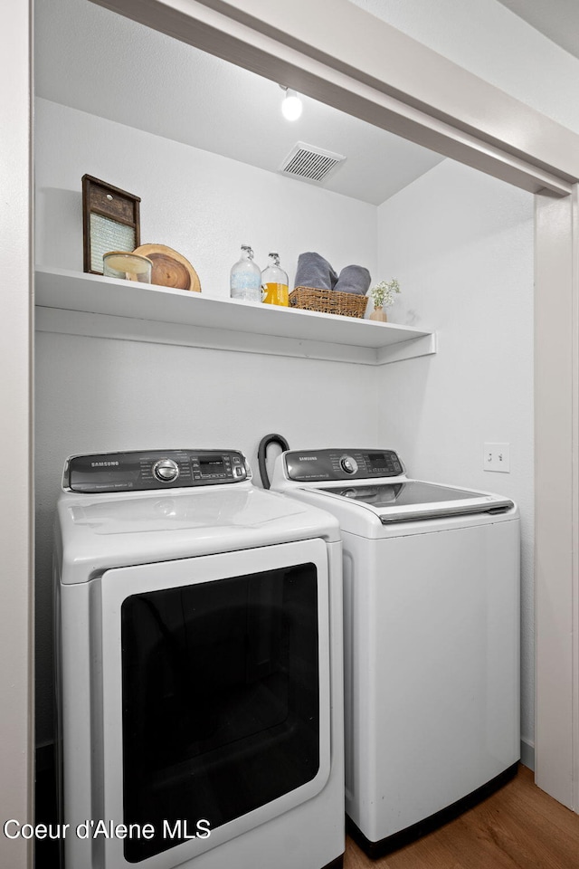1125 N Shannon Ln, Post Falls, ID 83854 - laundry area featuring separate washer and dryer and wood finished floors