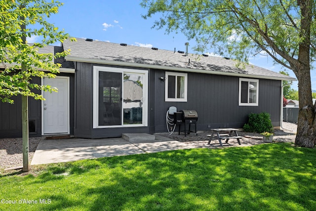 1125 N Shannon Ln, Post Falls, ID 83854 - back of property with a yard, a patio, and roof with shingles