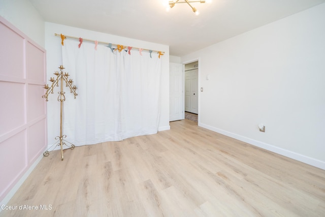 1707 E 2nd Ave, Post Falls, ID 83854 - unfurnished bedroom with light wood-type flooring and baseboards
