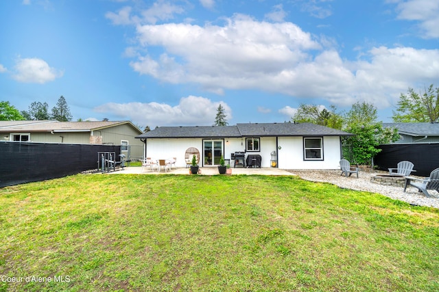 1707 E 2nd Ave, Post Falls, ID 83854 - rear view of property with an outdoor fire pit and a patio area