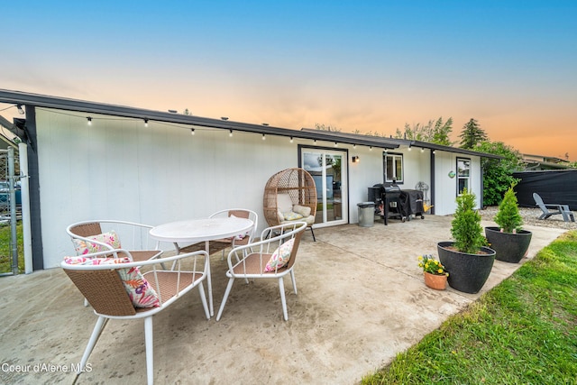1707 E 2nd Ave, Post Falls, ID 83854 - back of property at dusk with a patio and outdoor dining space