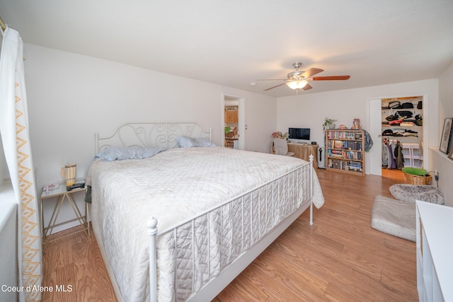 1707 E 2nd Ave, Post Falls, ID 83854 - bedroom with light wood-type flooring, a spacious closet, a ceiling fan, and a closet