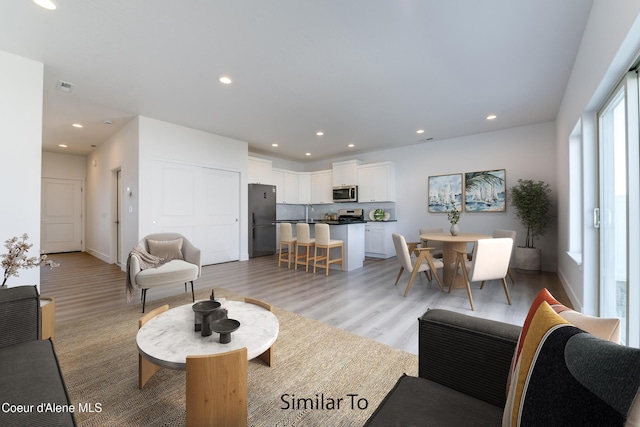 691 N Creative Way, Post Falls, ID 83854 - living room featuring light wood-style flooring, recessed lighting, and baseboards
