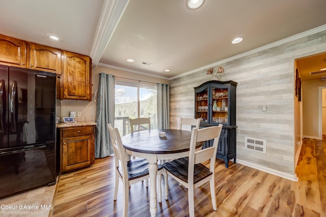 7485 E Revilo Point Rd, Hayden, ID 83835 - dining room featuring crown molding, recessed lighting, baseboards, light wood-style flooring, and an accent wall