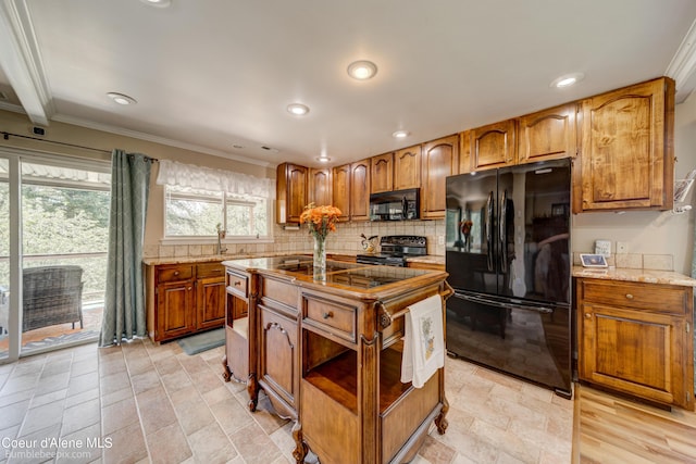 7485 E Revilo Point Rd, Hayden, ID 83835 - kitchen with black appliances, crown molding, backsplash, brown cabinetry, and light stone countertops