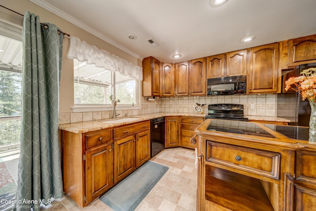 7485 E Revilo Point Rd, Hayden, ID 83835 - kitchen with black appliances, brown cabinets, crown molding, a sink, and healthy amount of natural light
