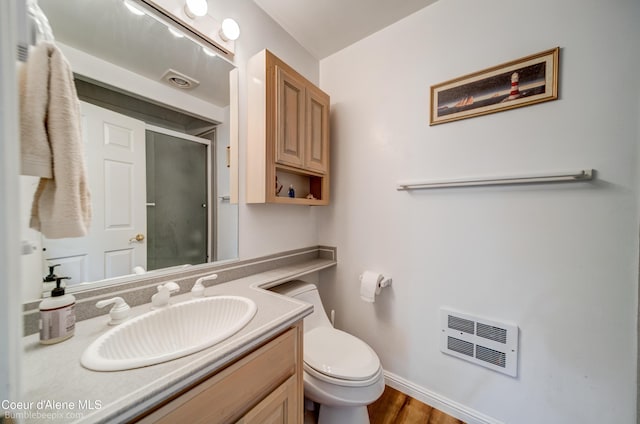 7485 E Revilo Point Rd, Hayden, ID 83835 - bathroom with heating unit, a stall shower, toilet, vanity, and baseboards