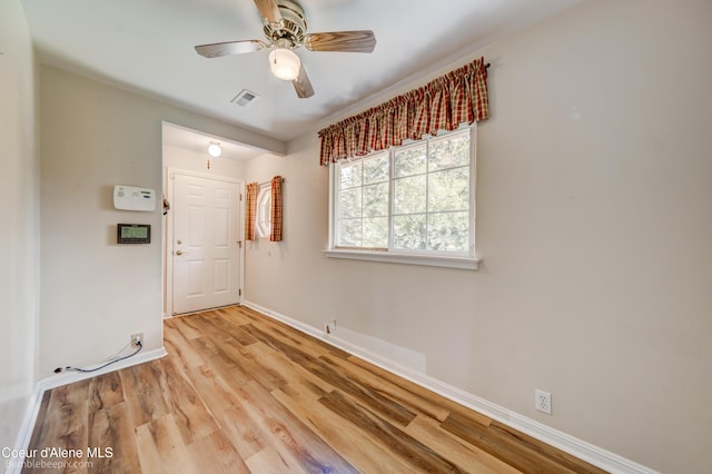 7485 E Revilo Point Rd, Hayden, ID 83835 - unfurnished room with baseboards, wood finished floors, and ceiling fan