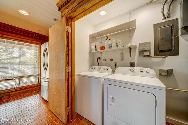 7485 E Revilo Point Rd, Hayden, ID 83835 - laundry room featuring electric panel, washing machine and dryer, brick patterned floors, and recessed lighting