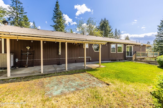 7485 E Revilo Point Rd, Hayden, ID 83835 - back of property with a patio, cooling unit, and board and batten siding