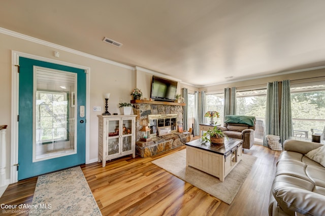 7485 E Revilo Point Rd, Hayden, ID 83835 - living area with ornamental molding, a fireplace, and light wood-type flooring