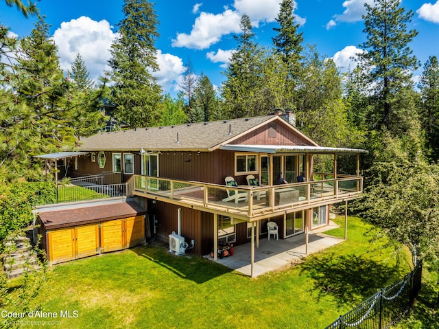 7485 E Revilo Point Rd, Hayden, ID 83835 - back of house featuring a patio, a chimney, a deck, a hot tub, and roof with shingles