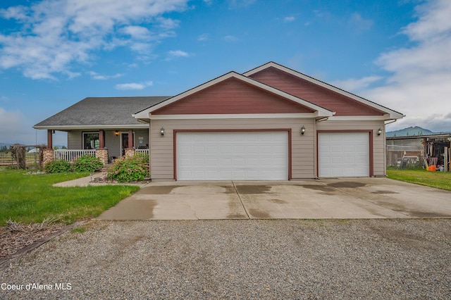 222 E Remington Rd, Athol, ID 83801 - view of front of property with concrete driveway, a garage, a porch, and a front lawn