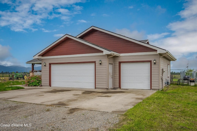 222 E Remington Rd, Athol, ID 83801 - view of front facade with concrete driveway, a mountain view, and an attached garage