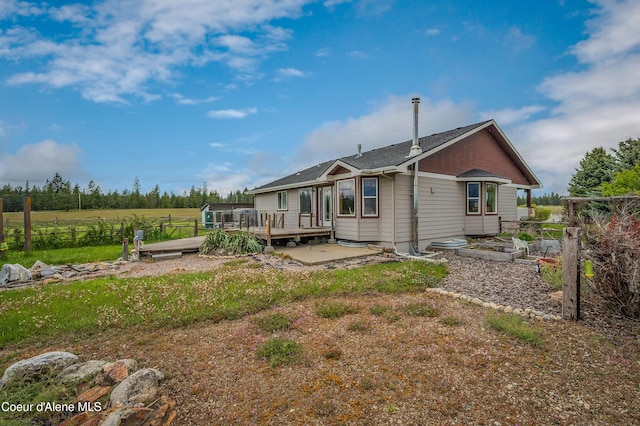 222 E Remington Rd, Athol, ID 83801 - rear view of house with a vegetable garden, a wooden deck, and a patio area