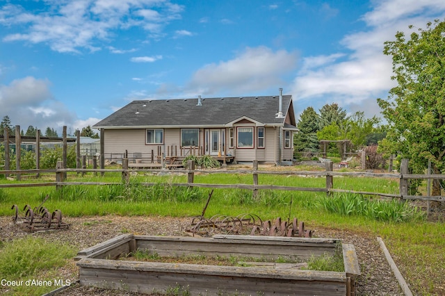 222 E Remington Rd, Athol, ID 83801 - rear view of property featuring a vegetable garden and a shingled roof