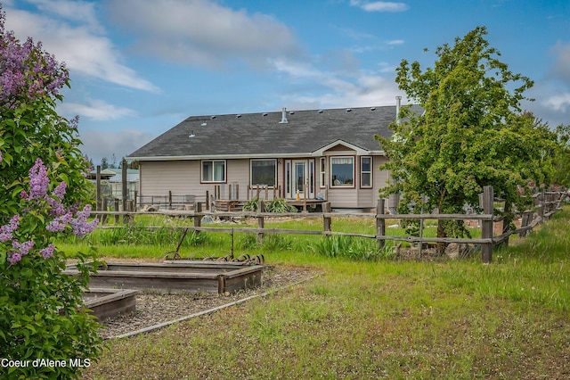 222 E Remington Rd, Athol, ID 83801 - rear view of property featuring a garden and a shingled roof