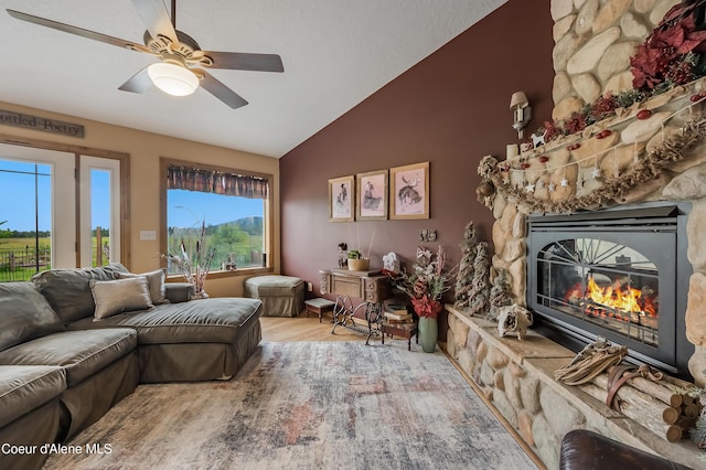 222 E Remington Rd, Athol, ID 83801 - living area with vaulted ceiling, a stone fireplace, wood finished floors, and ceiling fan